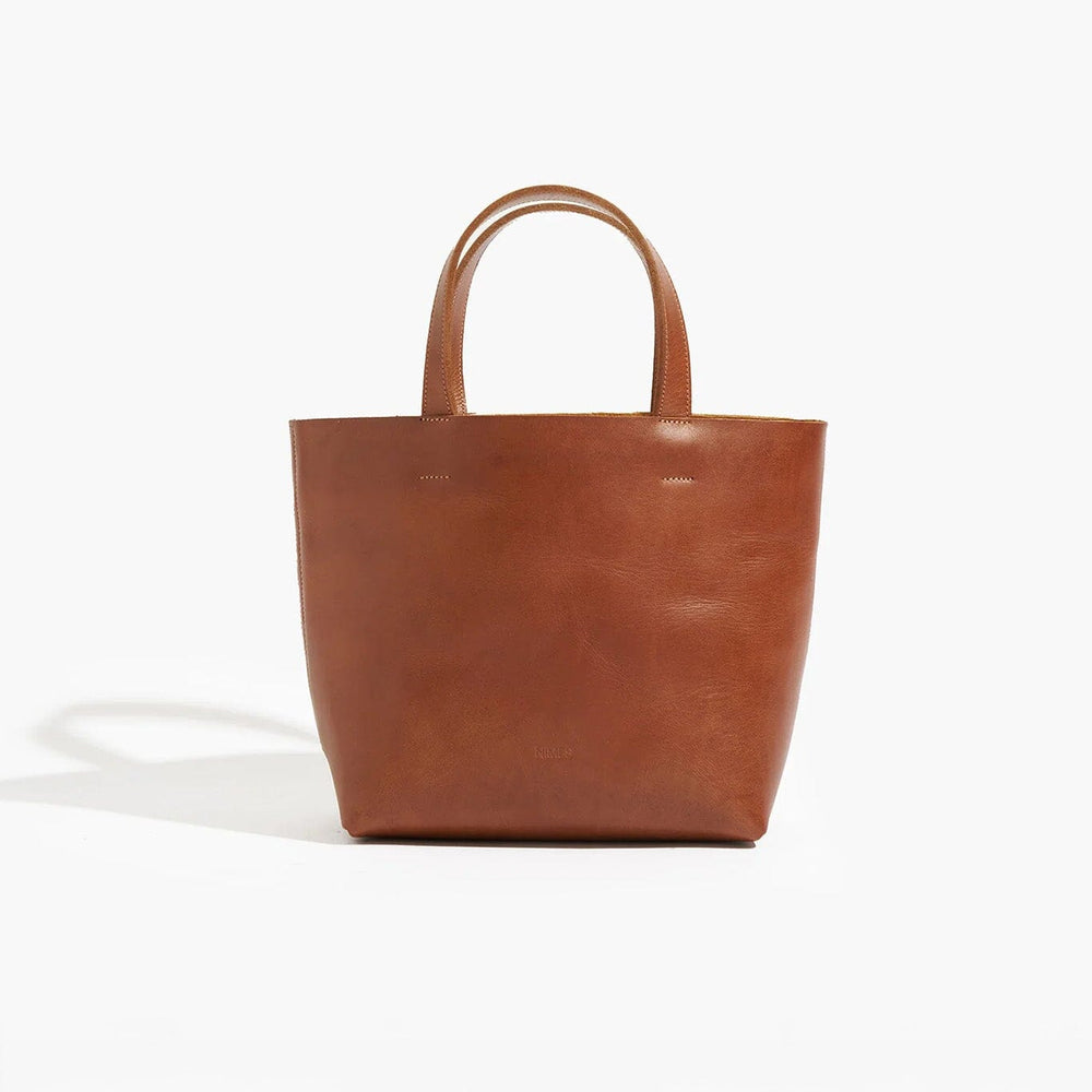 Brown leather tote bag on a white background