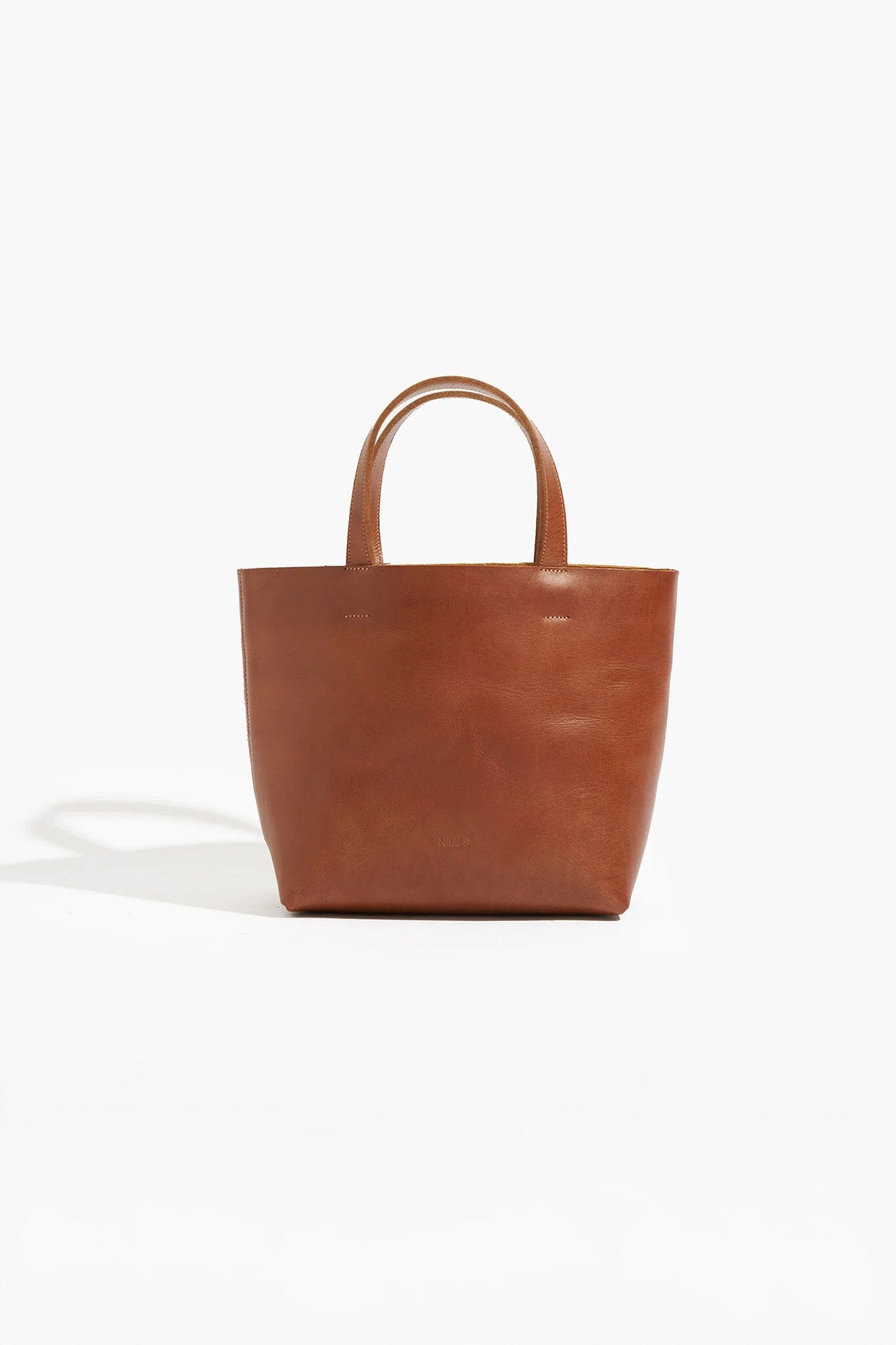 Brown leather tote bag on a white background