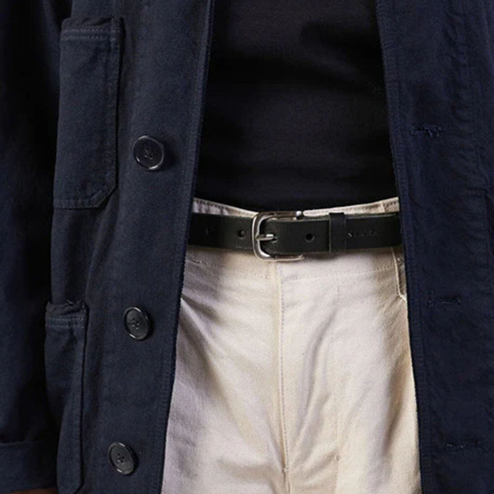 Person wearing a black jacket, black shirt, and beige pants with a black belt.