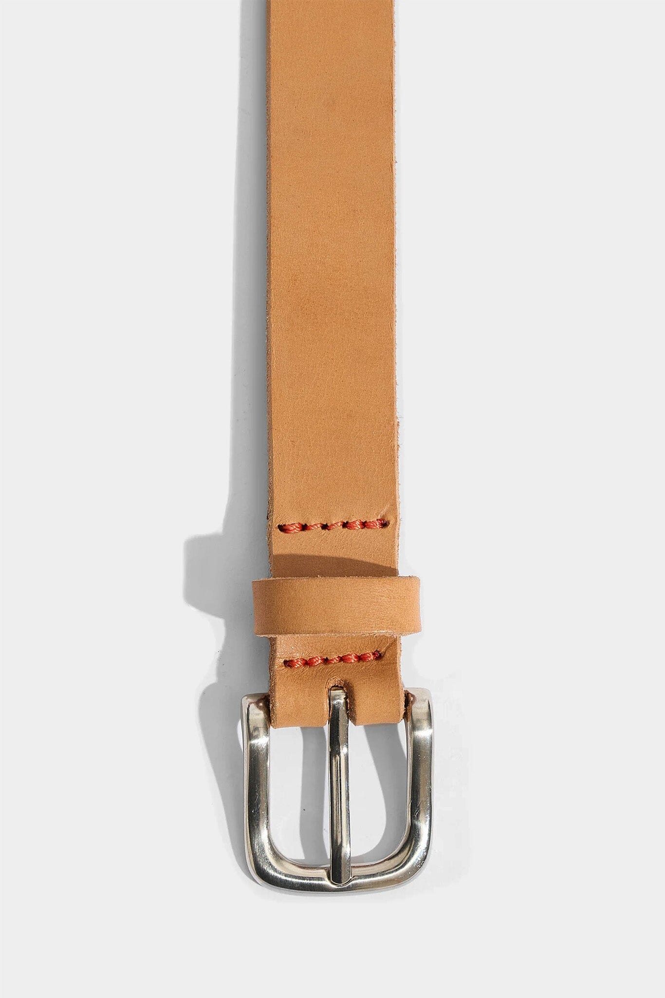 Tan leather belt with a silver buckle on a white background
