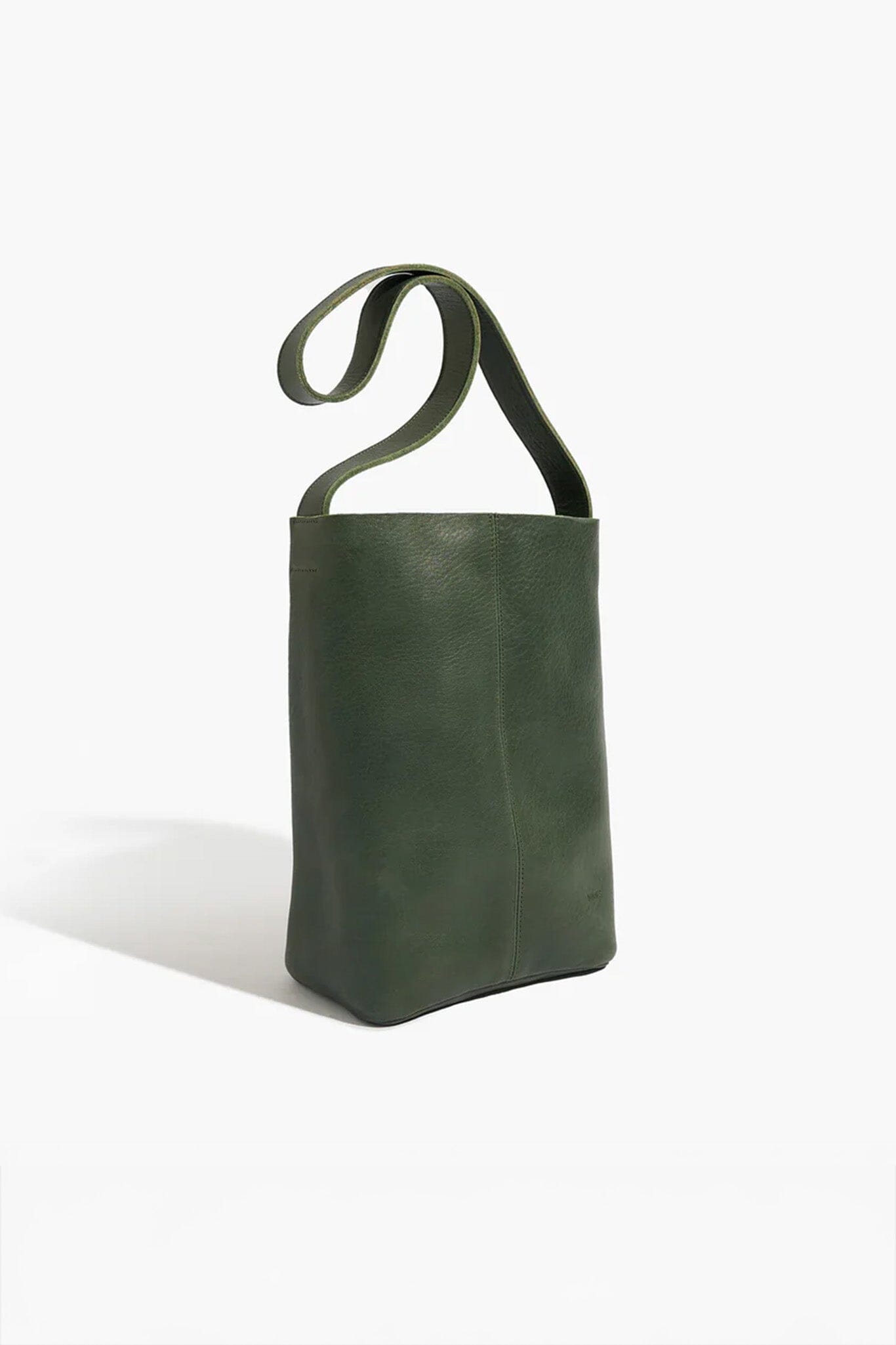 Green leather bag with a wide shoulder strap on a white background