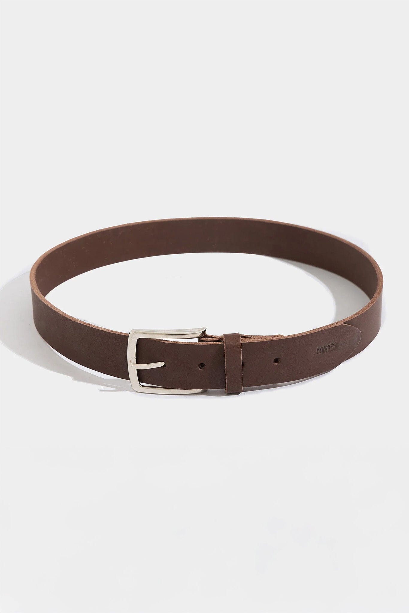 Brown leather belt with silver buckle on a white background
