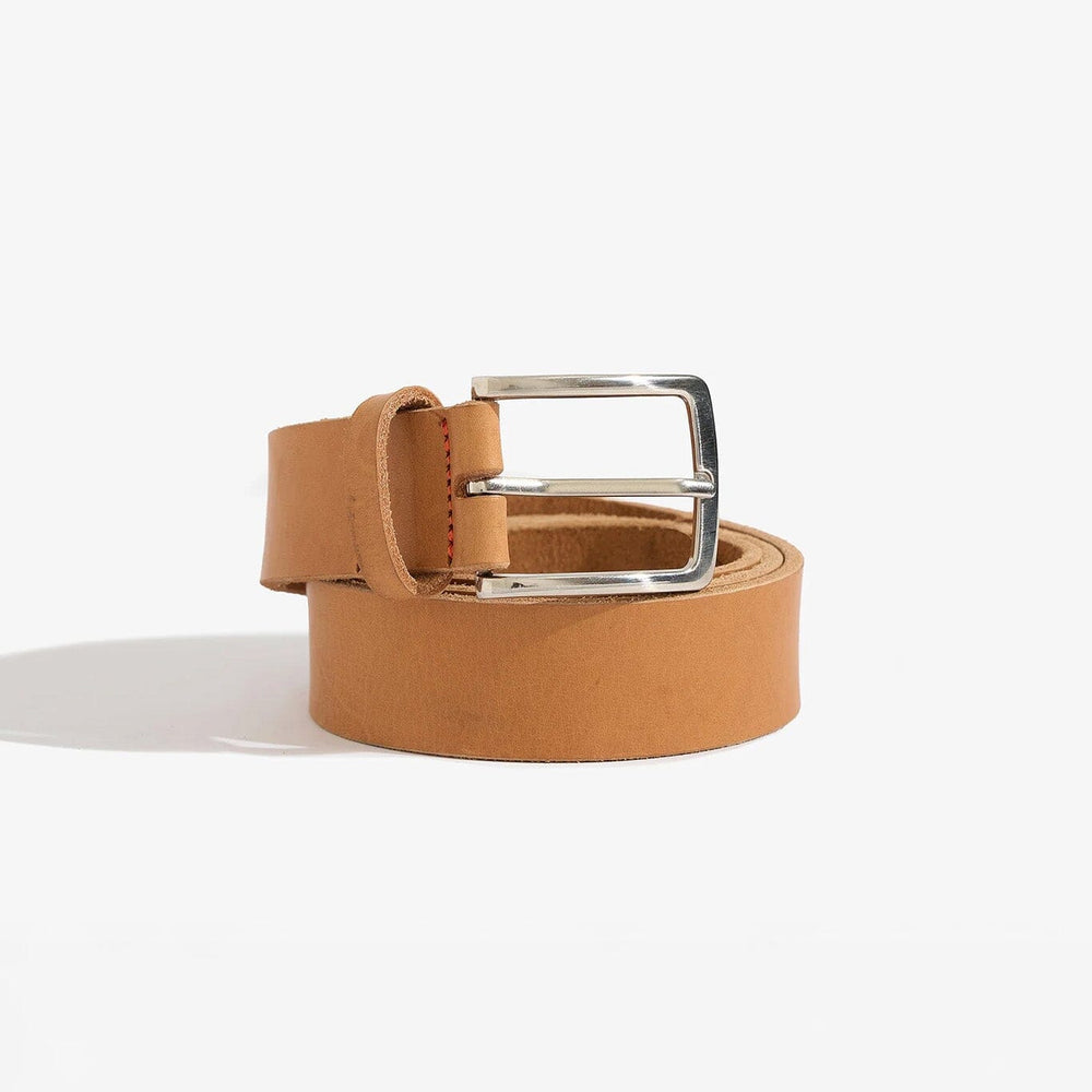 
                  
                    Tan leather belt with a silver buckle on a white background
                  
                