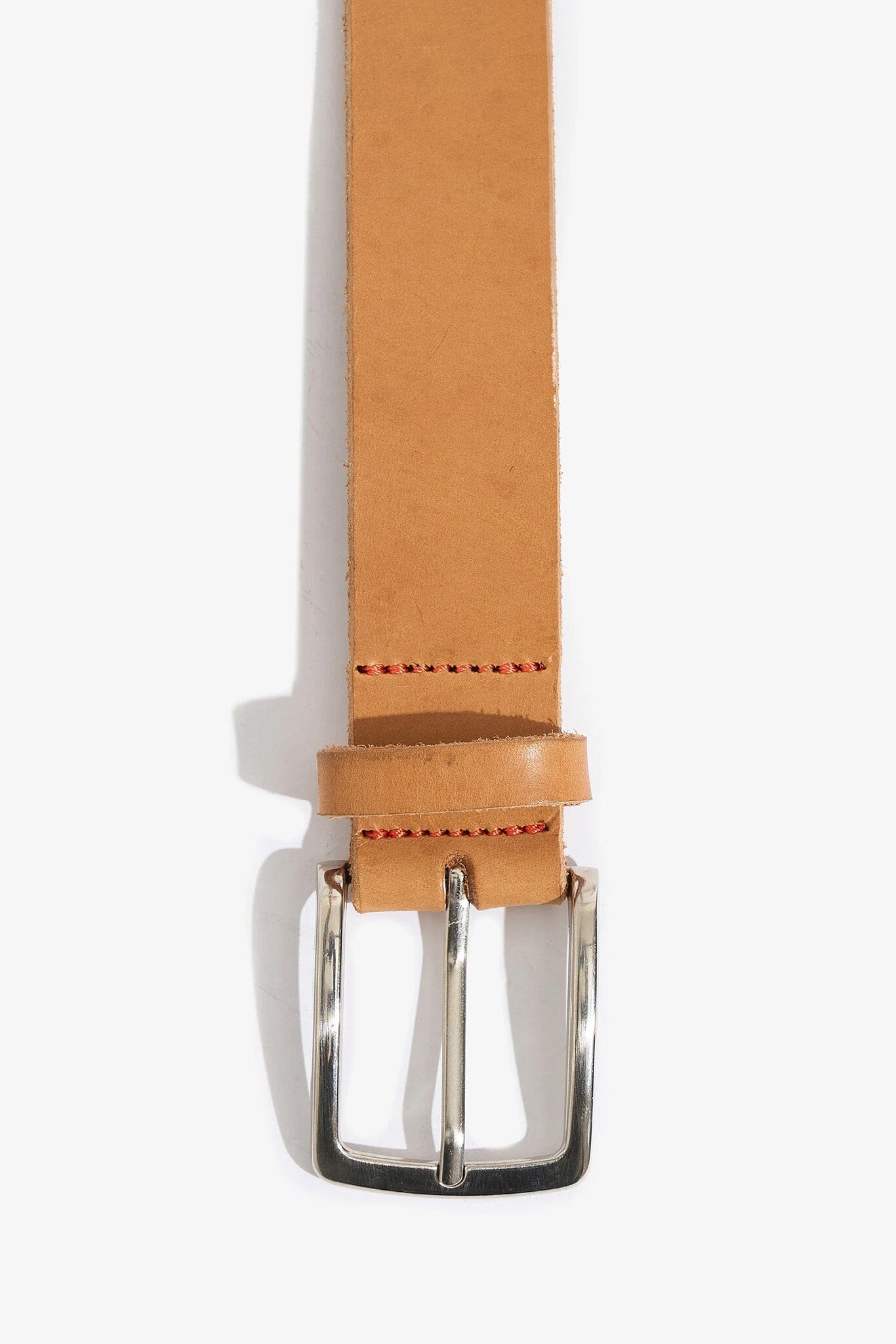 Tan leather belt with a silver buckle on a white background