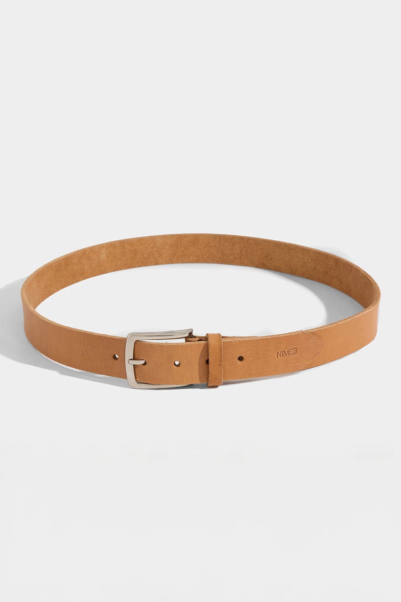 Tan belt with a silver buckle on a white background