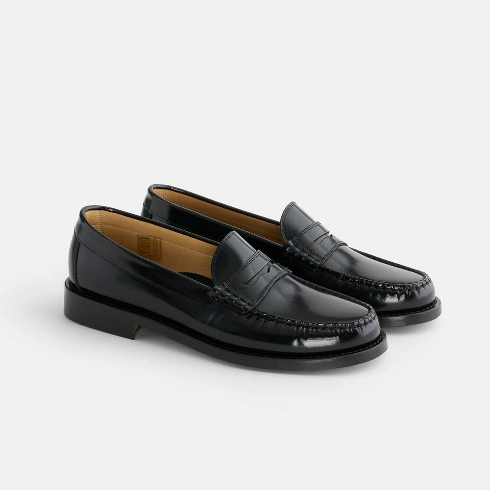 Pair of black loafers on a light gray background