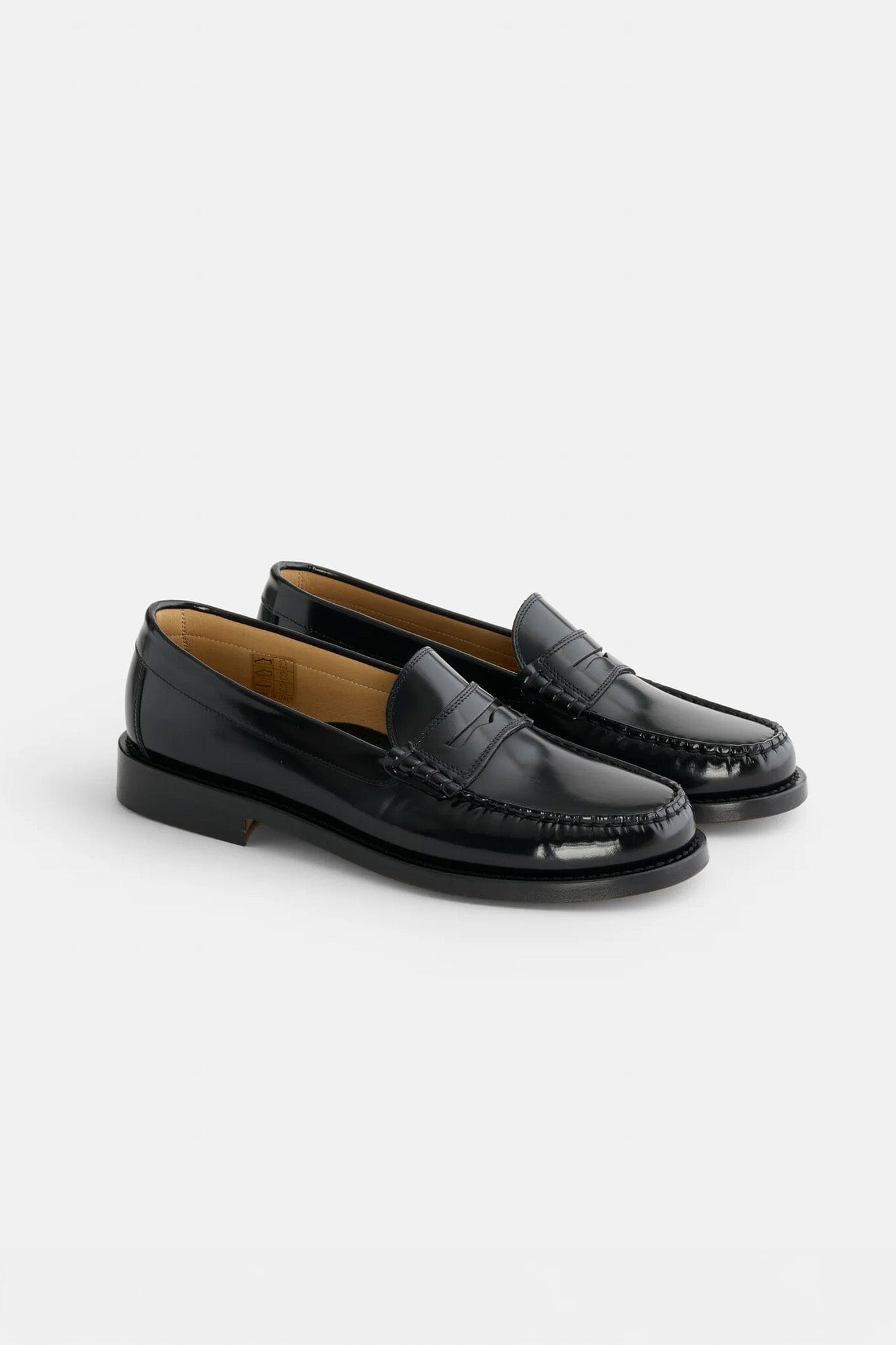 Pair of black loafers on a light gray background