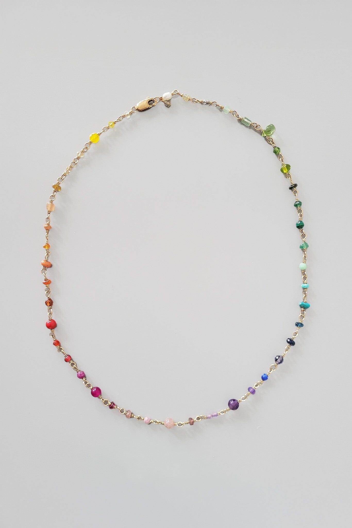 Multicolored beaded necklace on a light gray background