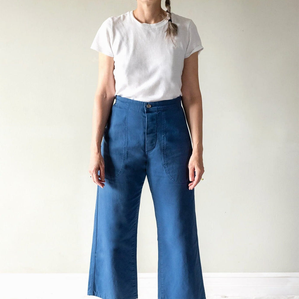 Person wearing a white t-shirt and blue jeans against a plain background