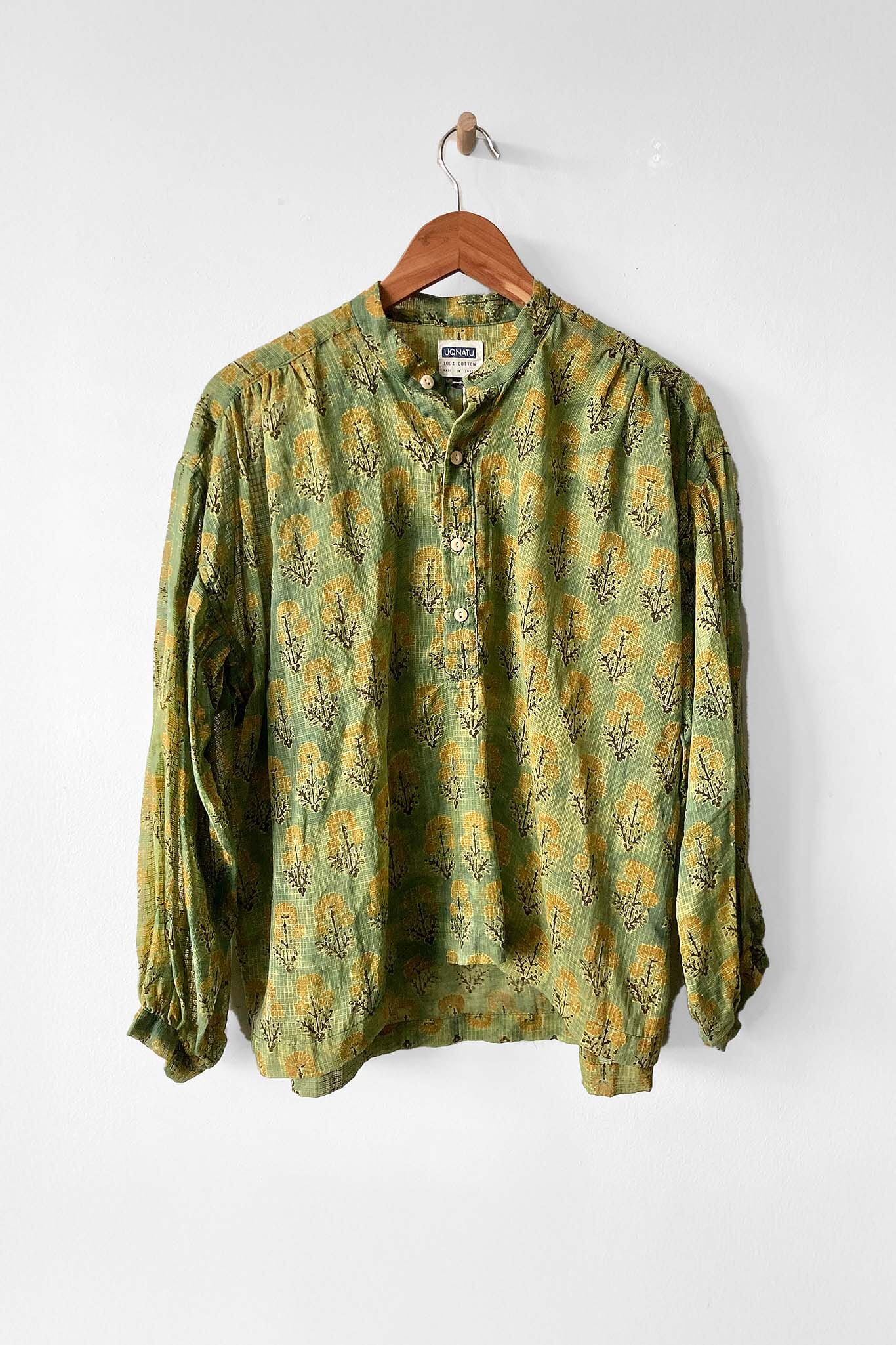 Cotton long sleeve peasant blouse featuring a spring green forest flowers print. Designed by Uqnatu, available to purchase at M.Patmos in Brooklyn, New York.