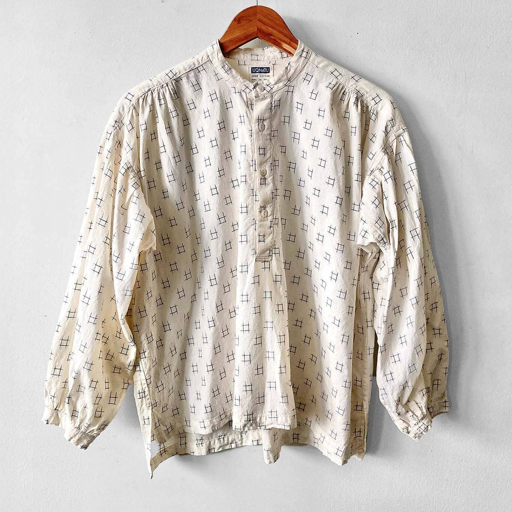 Cotton long sleeve button up blouse featuring a blue Ikat pattern. Designed by Uqnatu, available to purchase at M.Patmos in Brooklyn, New York.