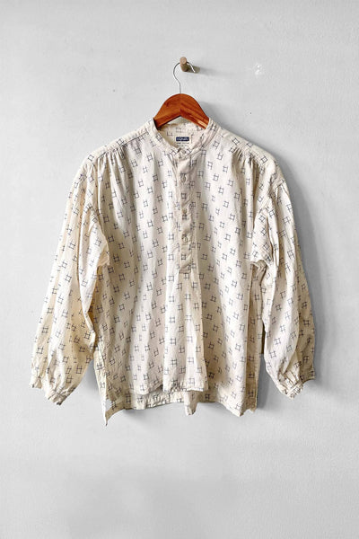 Cotton long sleeve button up blouse featuring a blue Ikat pattern. Designed by Uqnatu, available to purchase at M.Patmos in Brooklyn, New York.