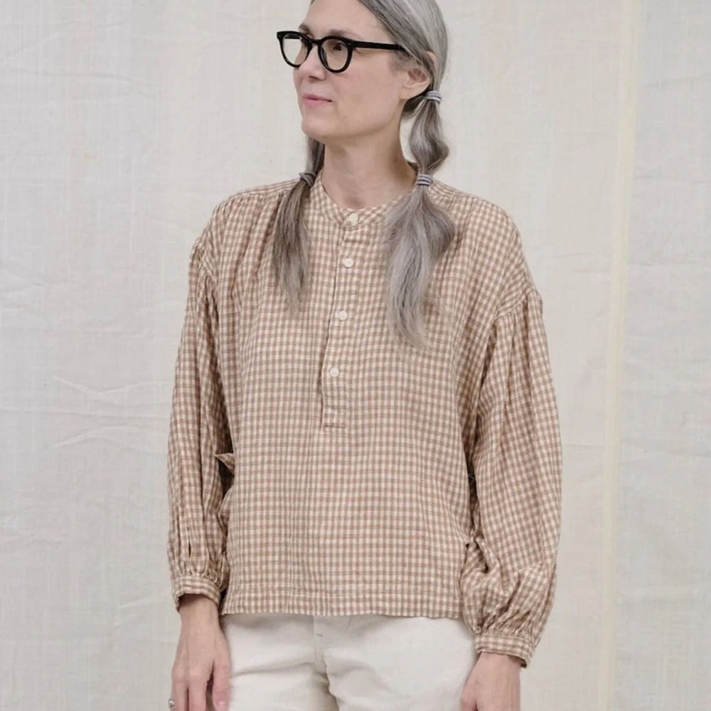 Cotton long sleeve peasant blouse featuring a brown gingham pattern. Designed by Uqnatu, available to purchase at M.Patmos in Brooklyn, New York.