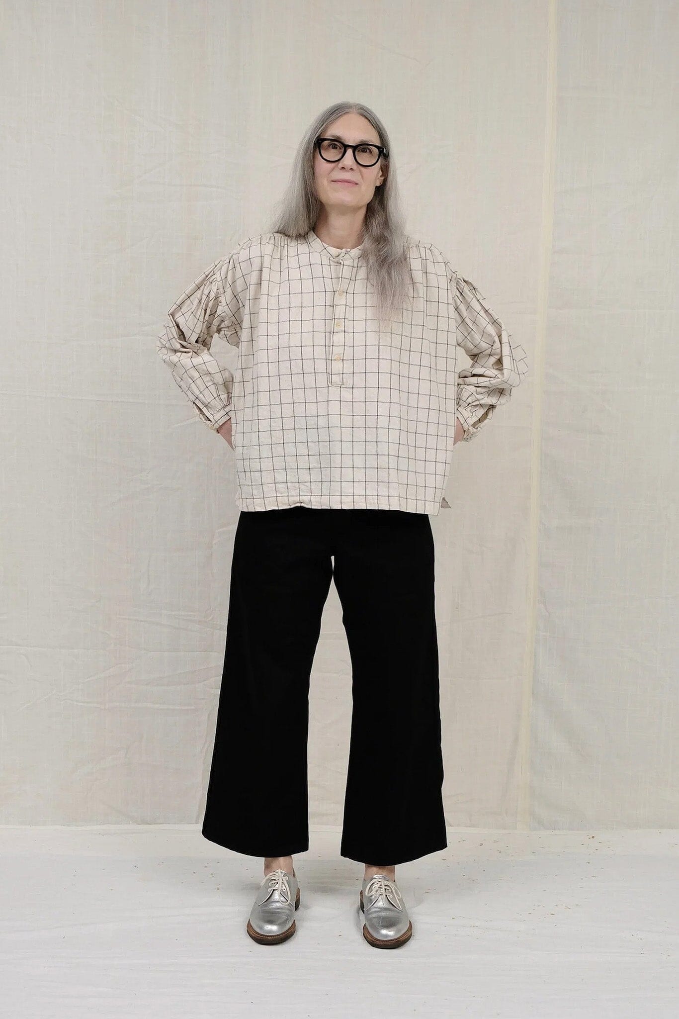 Cotton long sleeve natural peasant blouse featuring a black windowpane pattern. Designed by Uqnatu, available to purchase at M.Patmos in Brooklyn, New York.