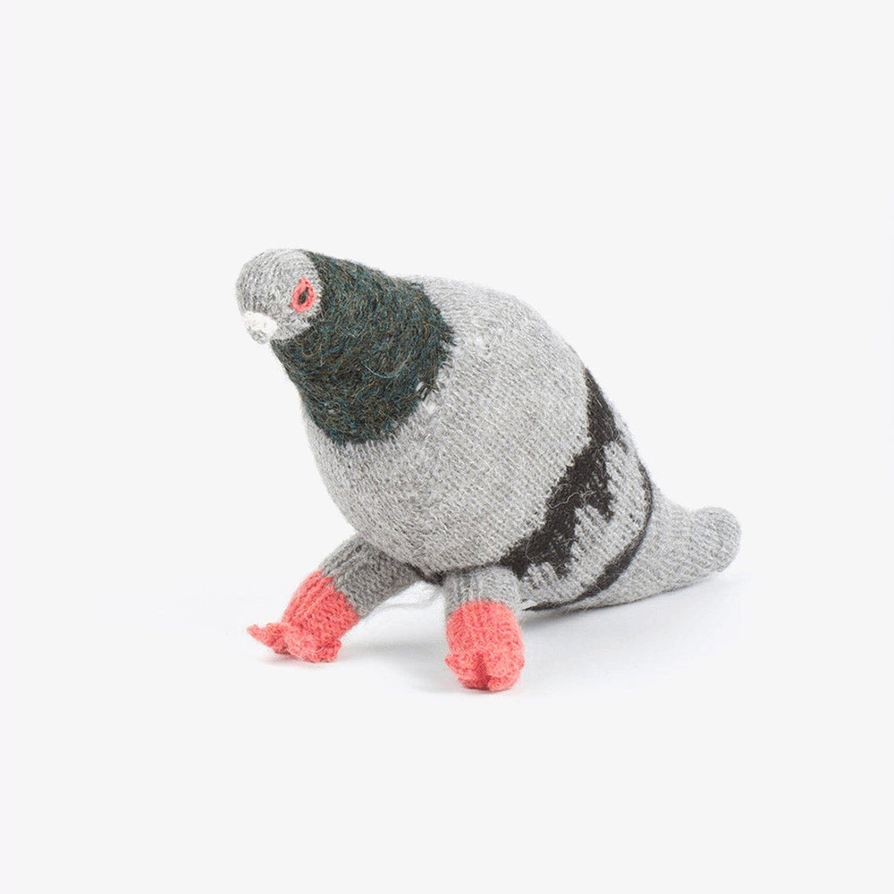Knitted grey felted stuffed pigeon on a white background