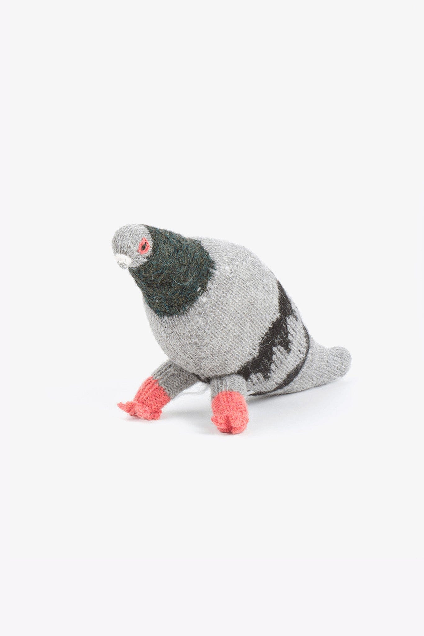 Knitted grey felted stuffed pigeon on a white background