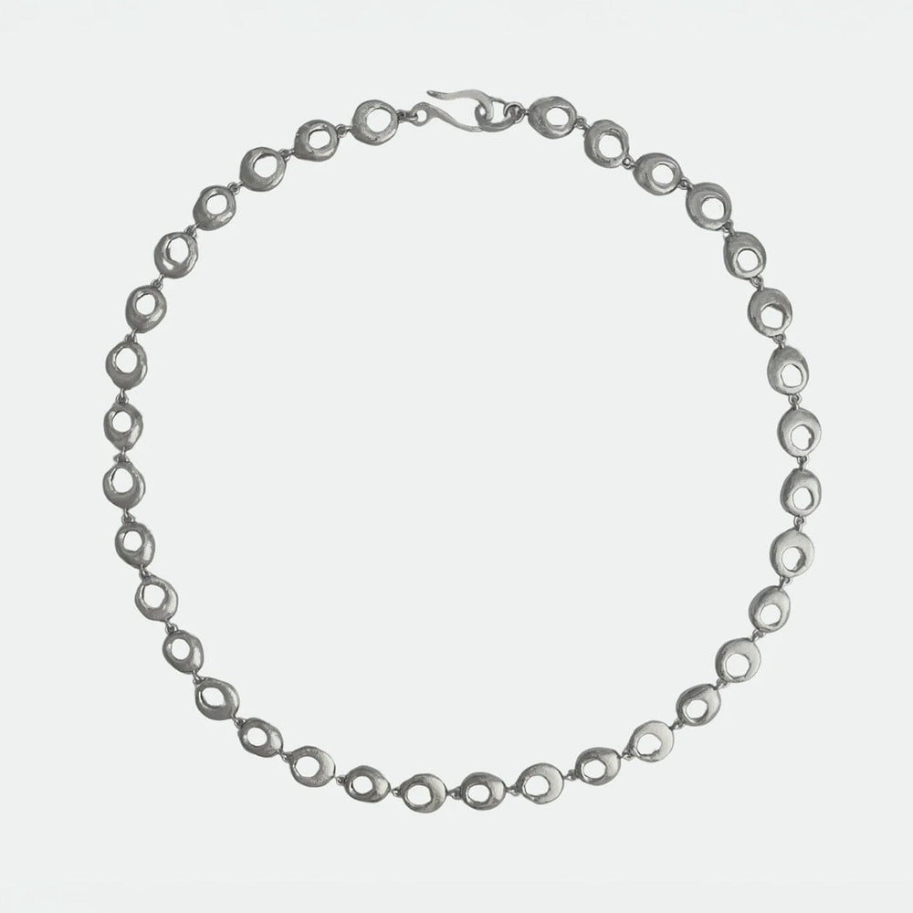 
                  
                    Silver oval chain necklace on a white background
                  
                