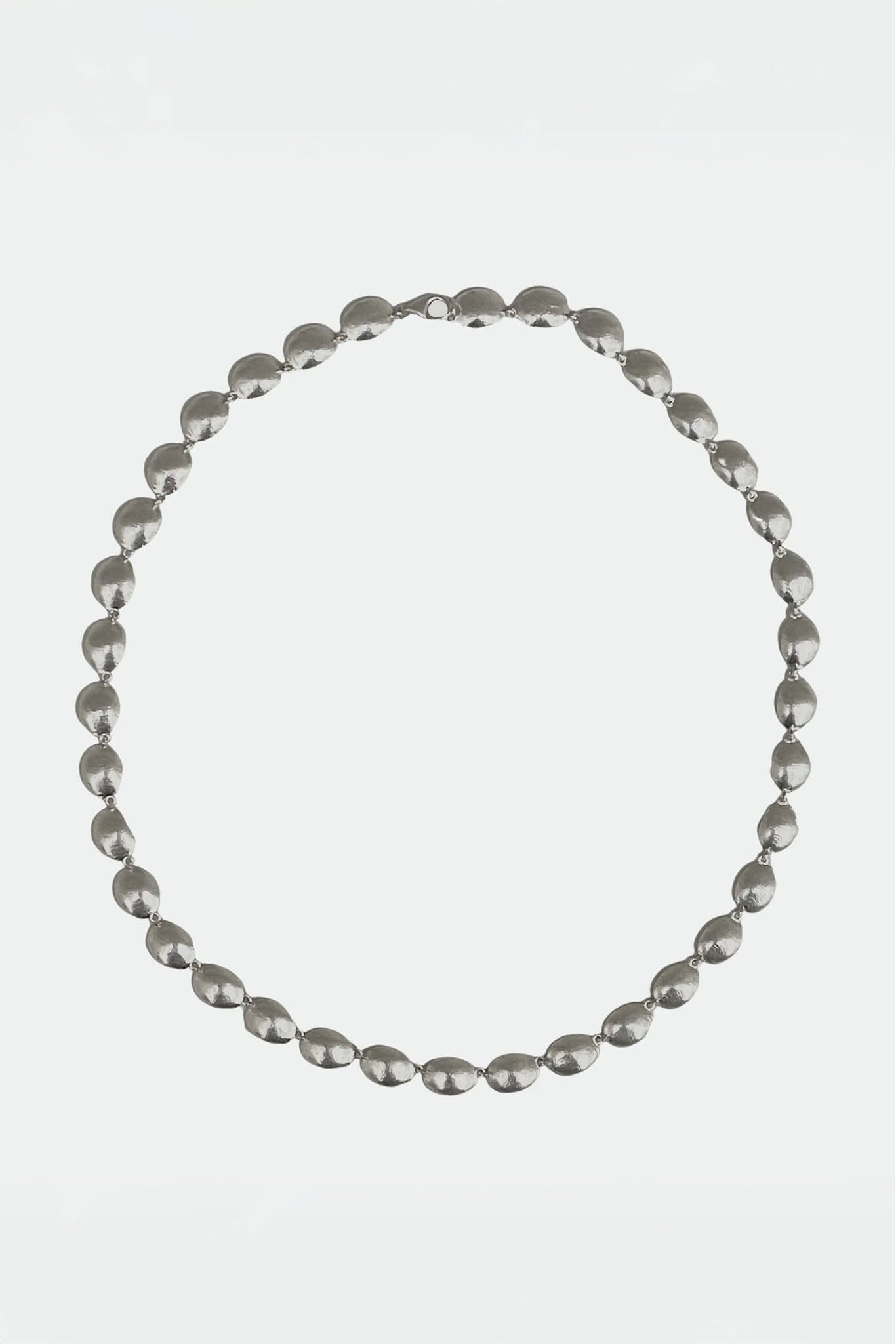 Silver beaded necklace on a white background