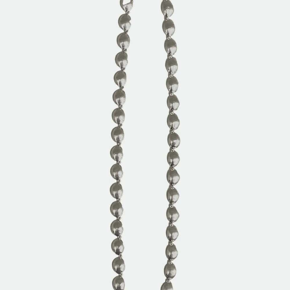 Silver beaded necklace on a white background