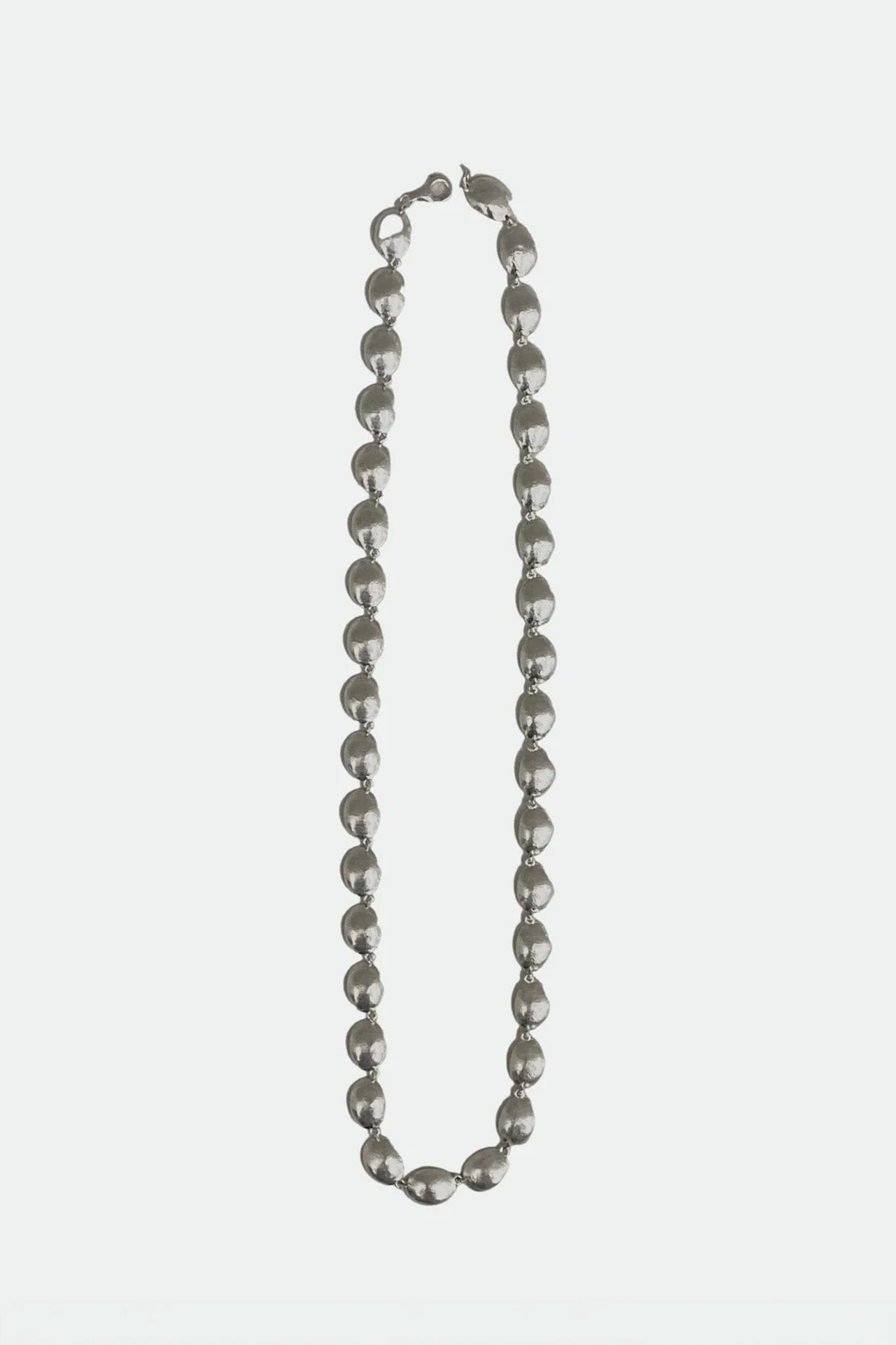 Silver beaded necklace on a white background