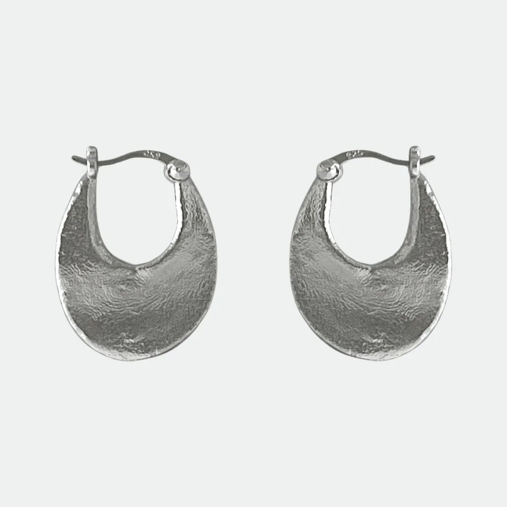 
                  
                    Pair of silver oval hoop earrings on a white background
                  
                