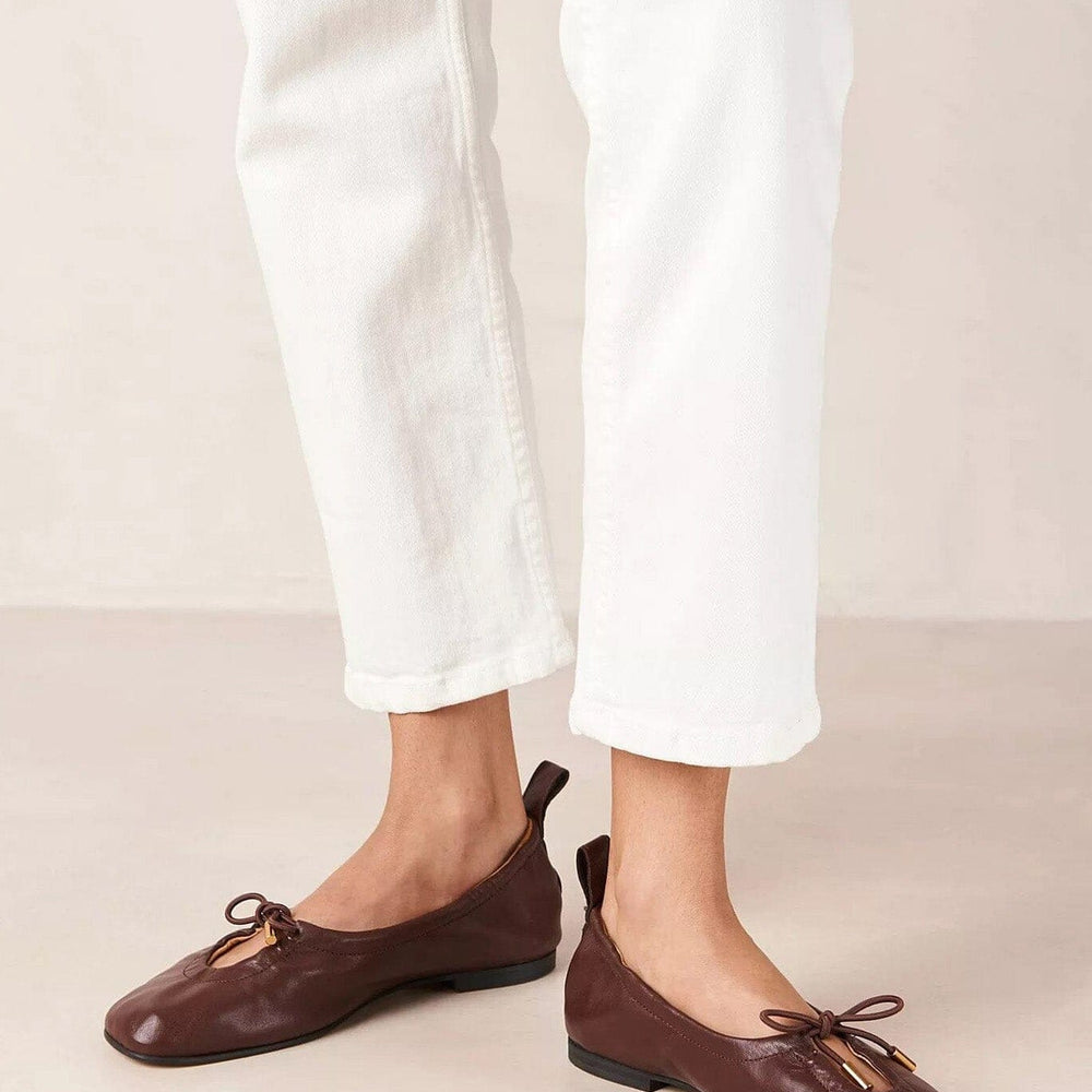 
                  
                    Person wearing brown square toe mary jane flat shoes
                  
                