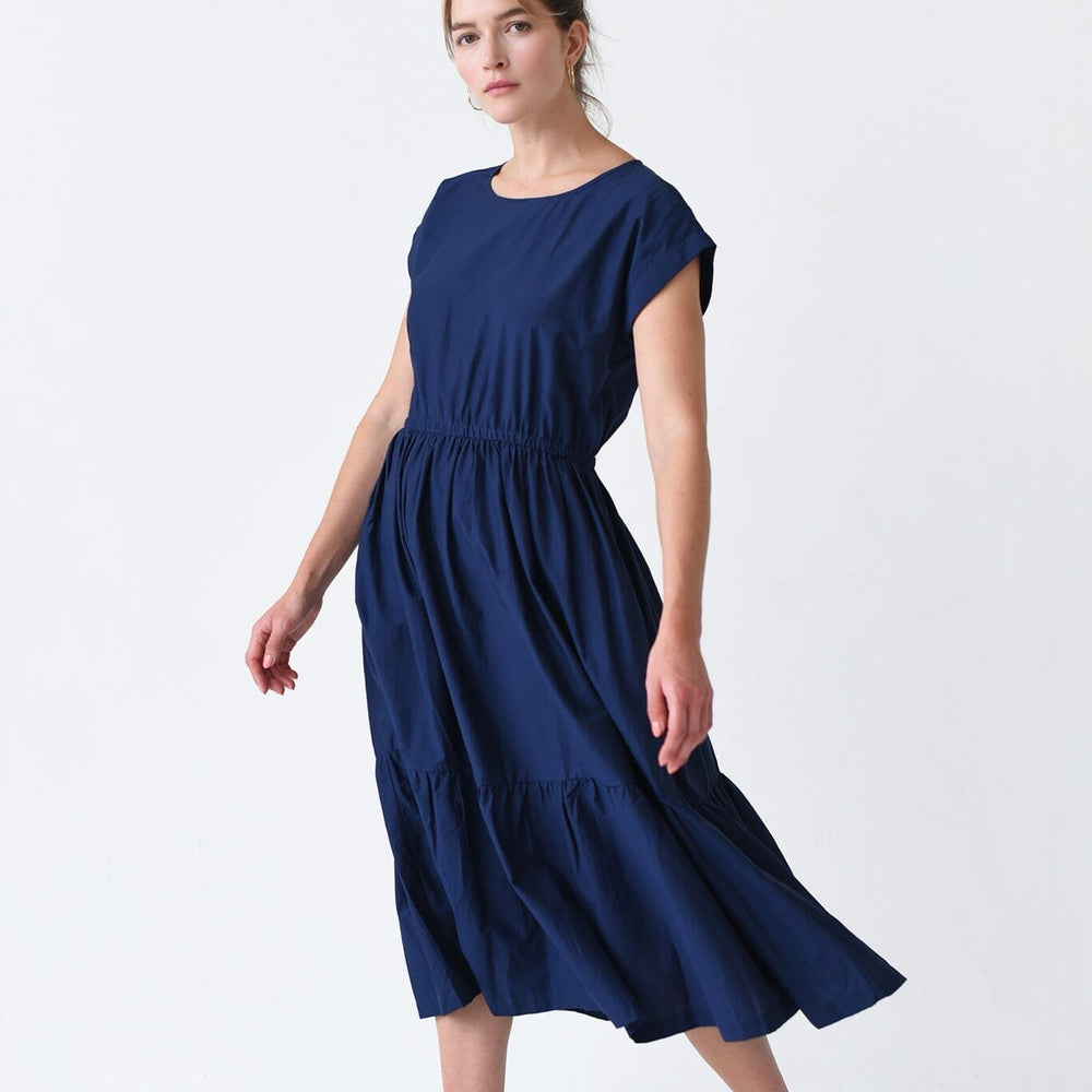 
                  
                    The M.PATMOS Navy Penelope Dress in medium, showcases a button-down front, relaxed fit, midi-length silhouette, and a waist belt for a flattering and versatile look.
                  
                