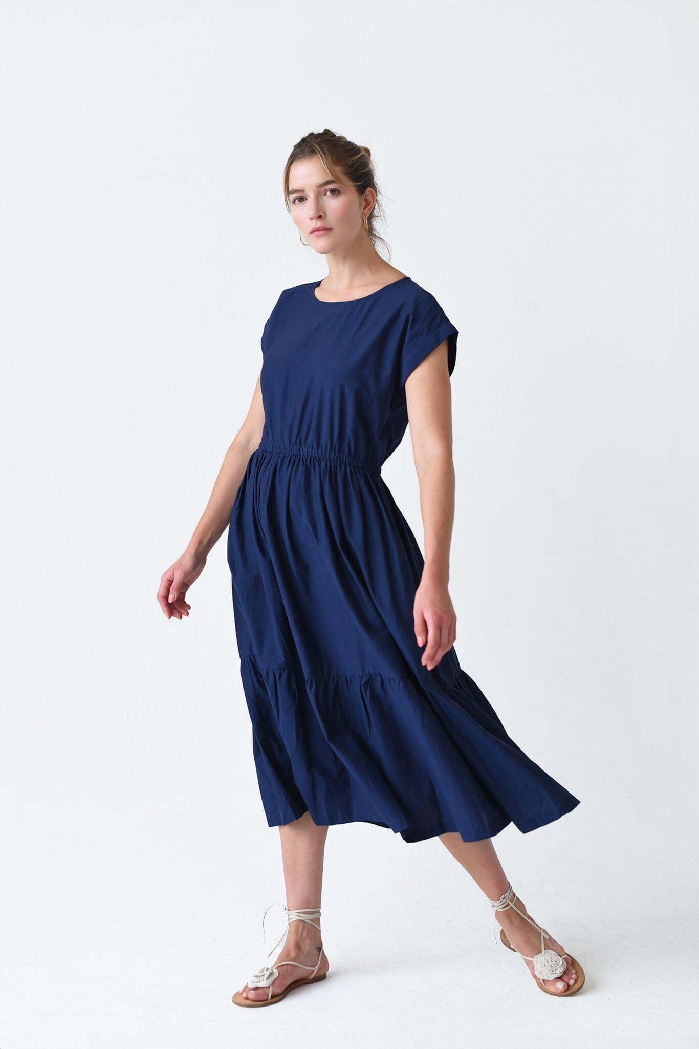 The M.PATMOS Navy Penelope Dress in medium, showcases a button-down front, relaxed fit, midi-length silhouette, and a waist belt for a flattering and versatile look.