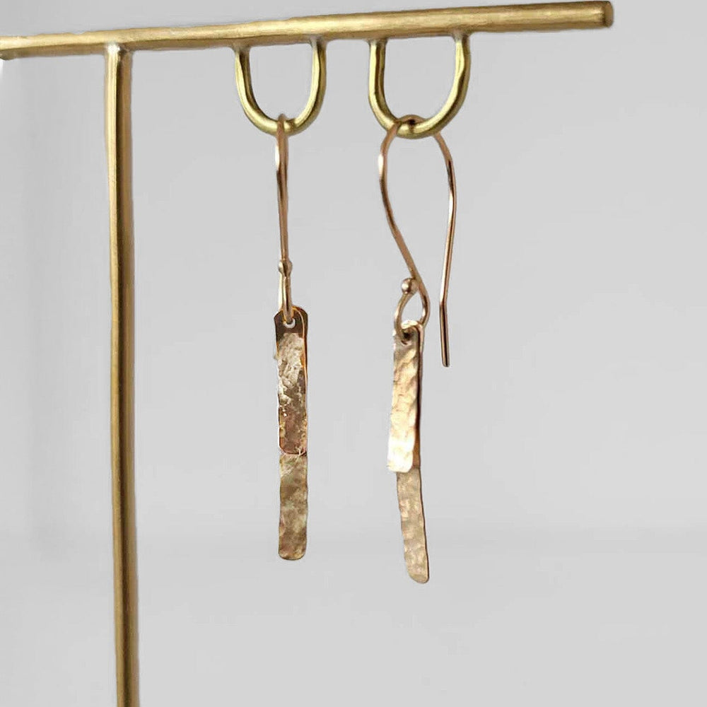 Minimalist 14k yellow gold hammered baguette earrings on gold ear wires. Handmade in Brooklyn.