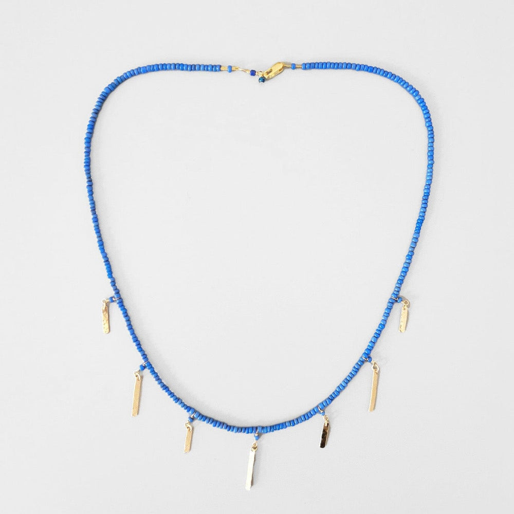 Handmade choker necklace with blue bali beads and 14k gold baguette charms. Handmade in Brooklyn, New York. 