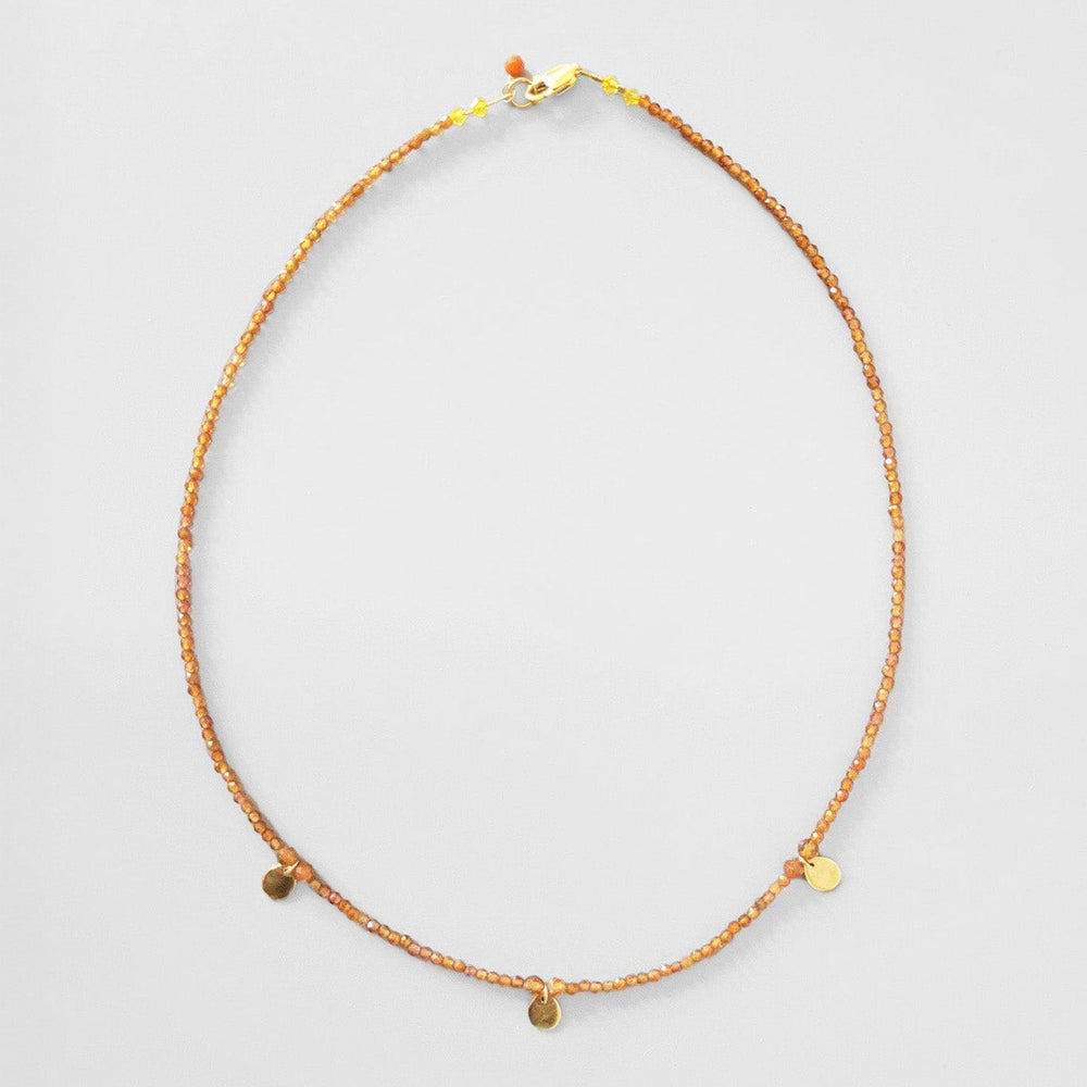 Beautiful orange carnelian gemstone necklace. Three 10k gold yellow circle charms. Available to purchase at M.Patmos in Brooklyn.