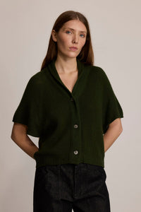 Model wearing M.PATMOS Ilam Cardigan in Forest with a cashmere silk knit, shawl collar and pearl buttons.