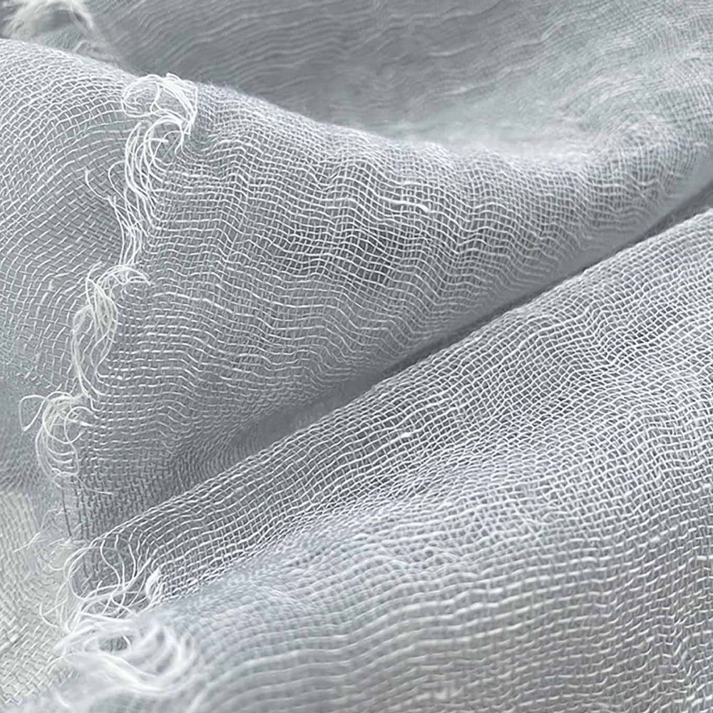 A close up shot of a silver handwoven scarf made of cashmere and linen