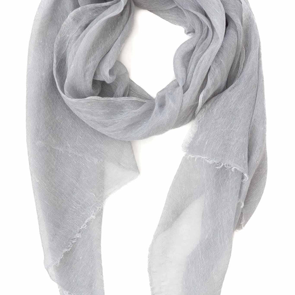 A silver handwoven scarf made of cashmere and linen, displayed on a white background.