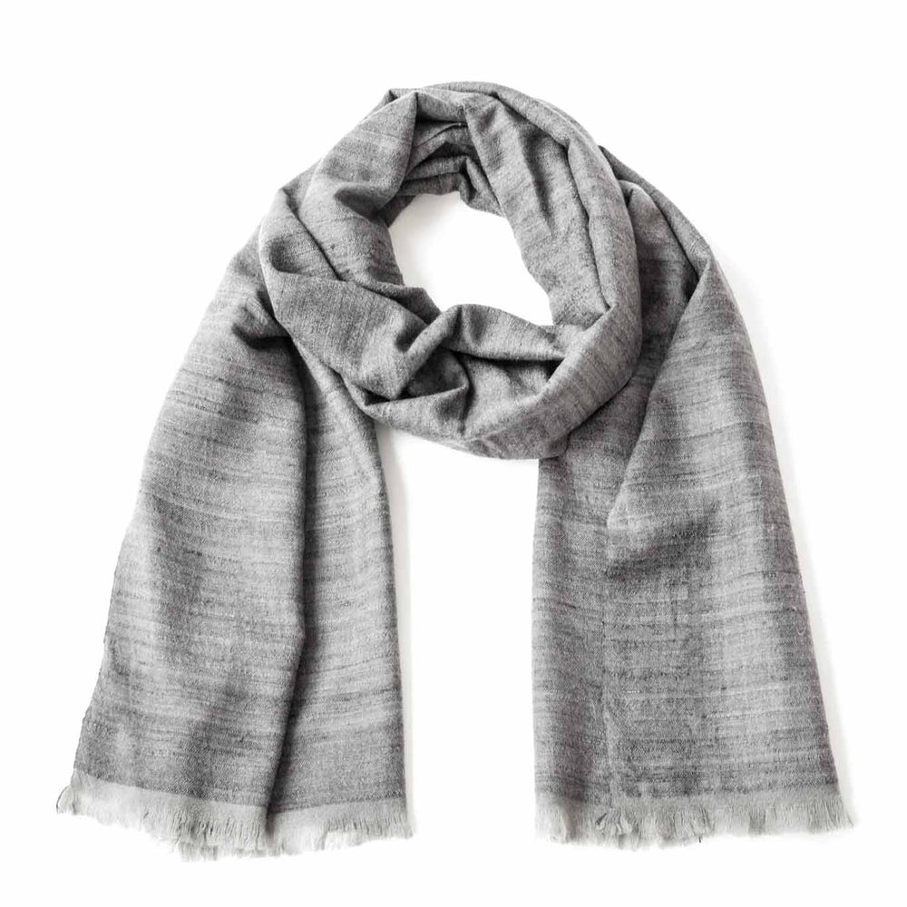 A silver handwoven scarf made of silk and cashmere, displayed on a white background