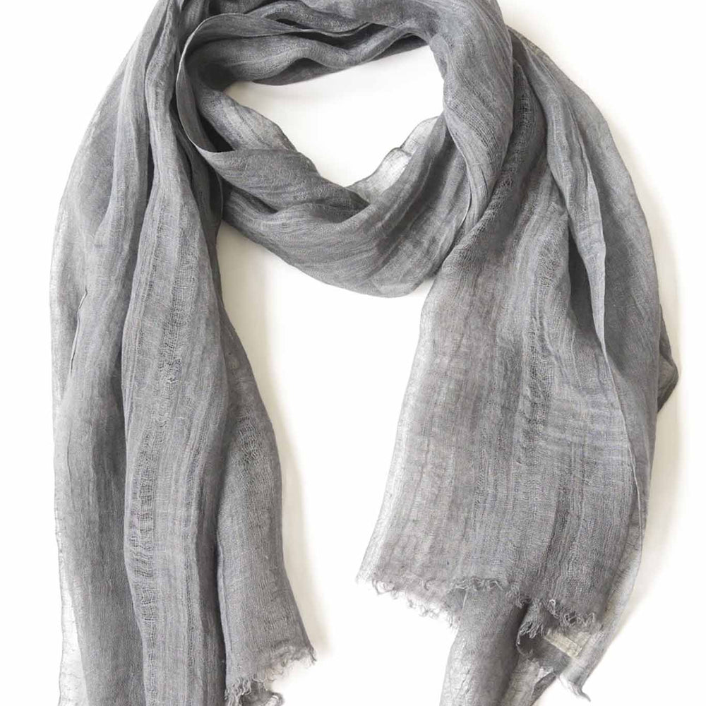 A silver handwoven scarf made of linen, displayed on a white background.