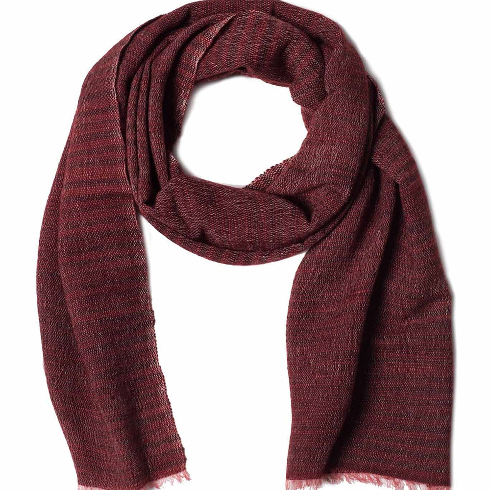 A scarf in oxblood color, displayed on a plain background, made from a blend of merino wool and cotton, handwoven in Nepal.