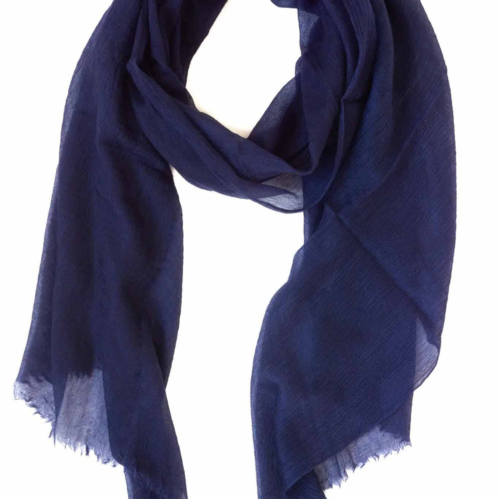 A navy blue cashmere scarf with frayed edges, displayed on a white background.