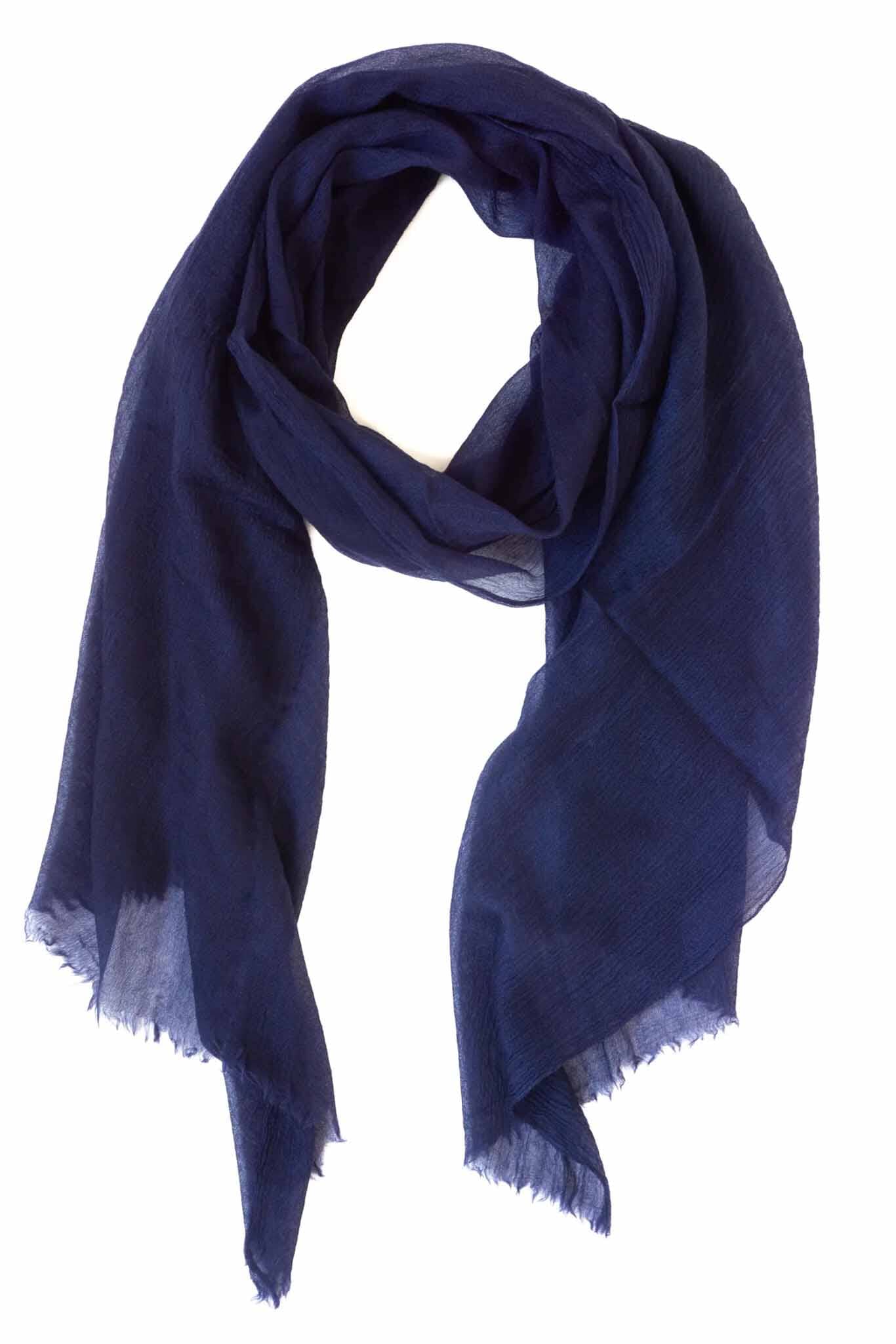 A navy blue cashmere scarf with frayed edges, displayed on a white background.