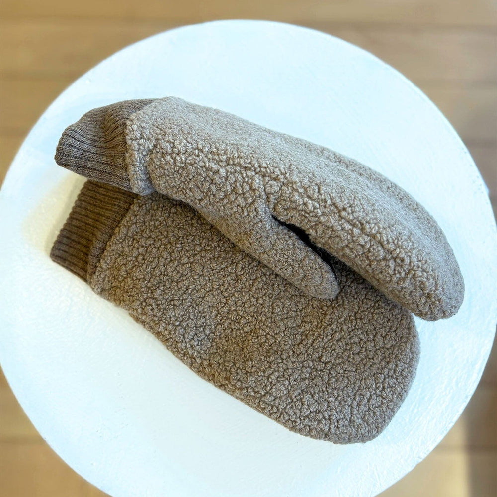 Pair of brown fleece mittens on a white background