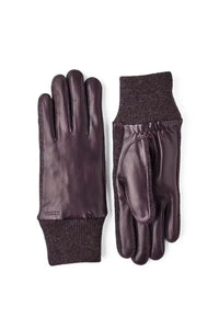 Pair of dark purple leather gloves with knit cuffs on a white background