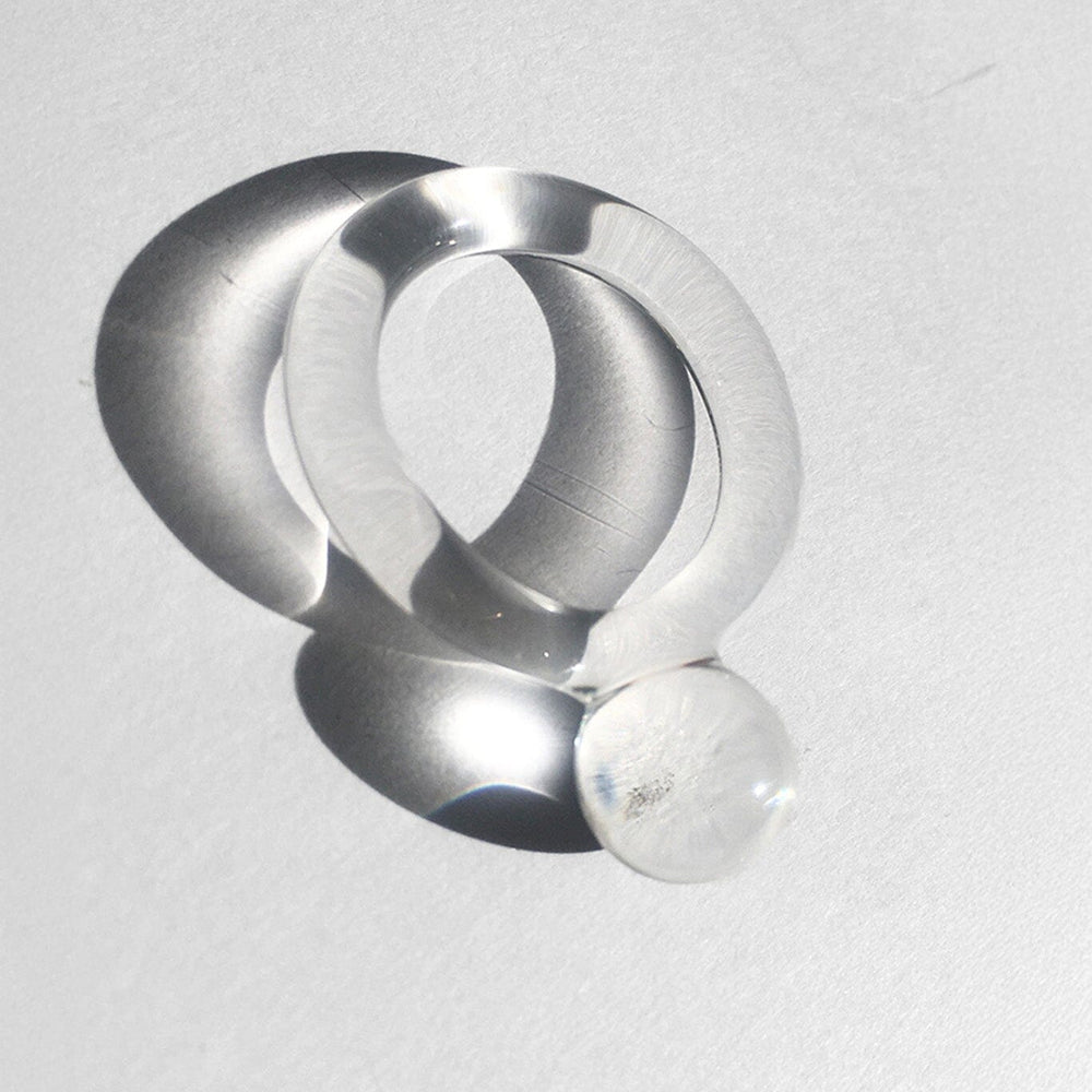 
                  
                    A clear handmade pyrex glass ring with a clear band and a small clear orb ball.
                  
                