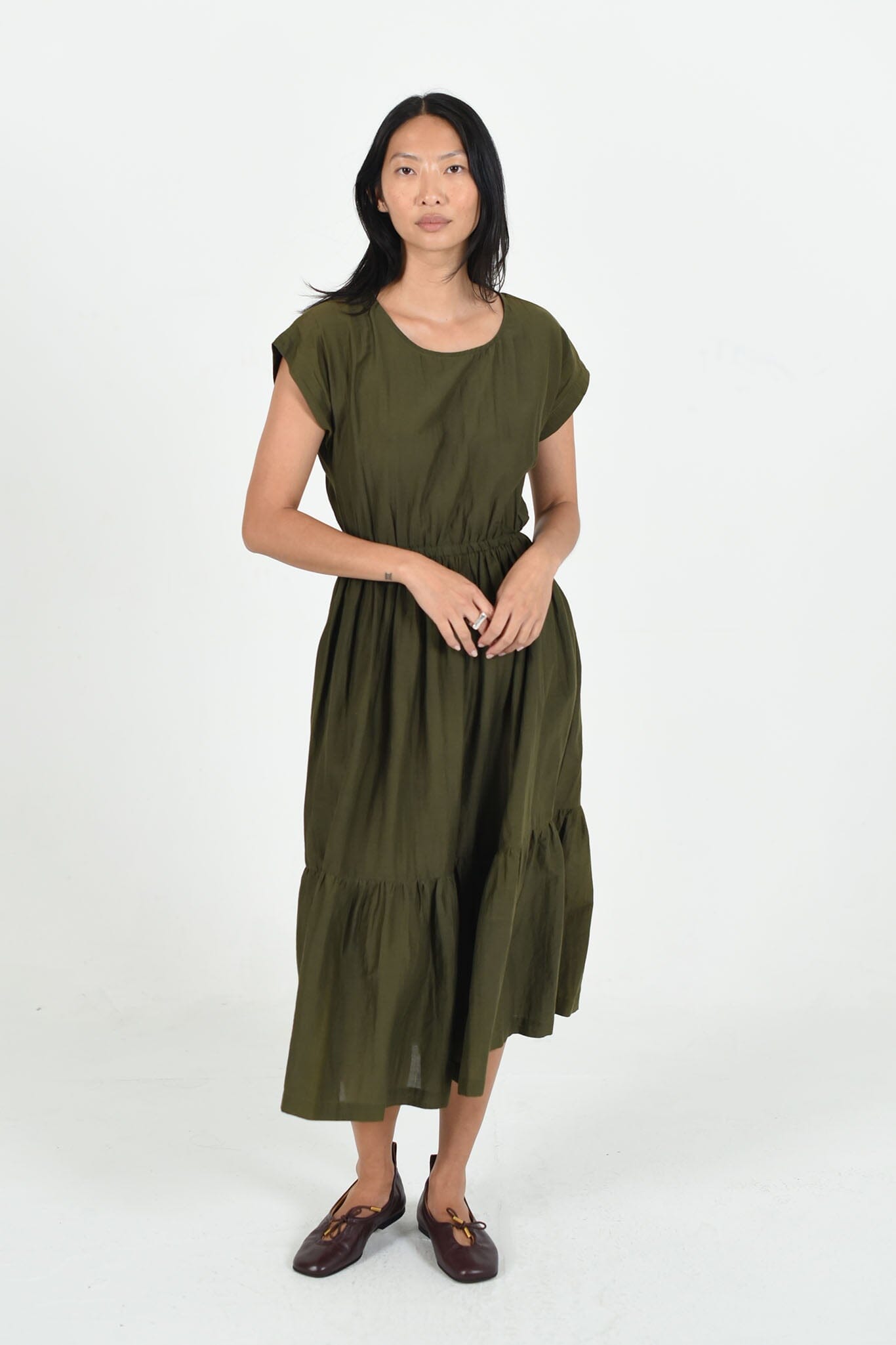 The M.PATMOS Olive Penelope Dress in large, features a relaxed fit, midi-length silhouette, button-down front, and belt at the waist for a flattering shape