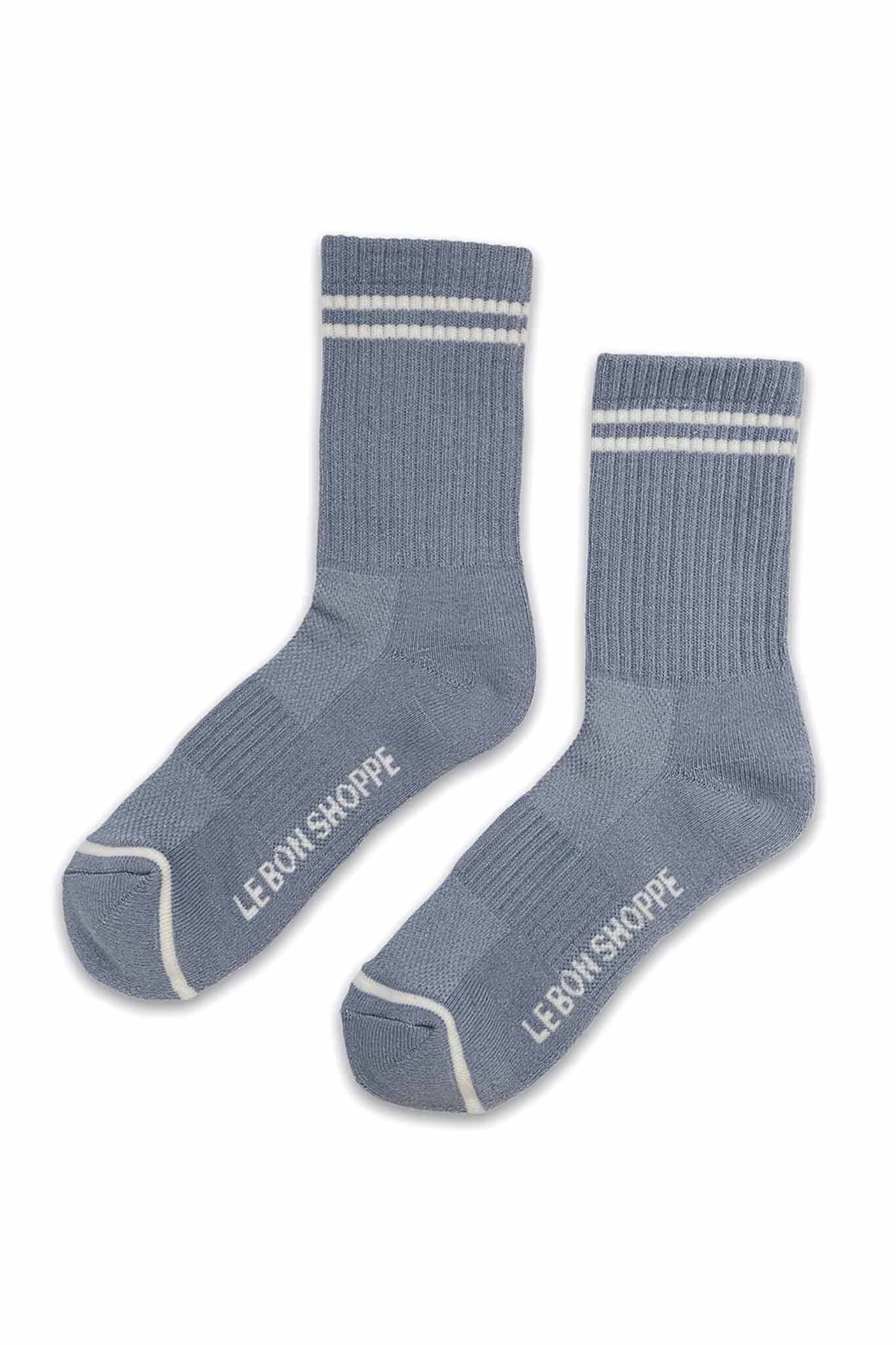 A flat shot of two ribbed grey blue crew socks