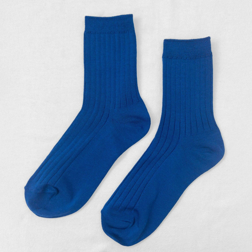 A pair of cobalt blue ribbed ankle socks displayed against a white background.