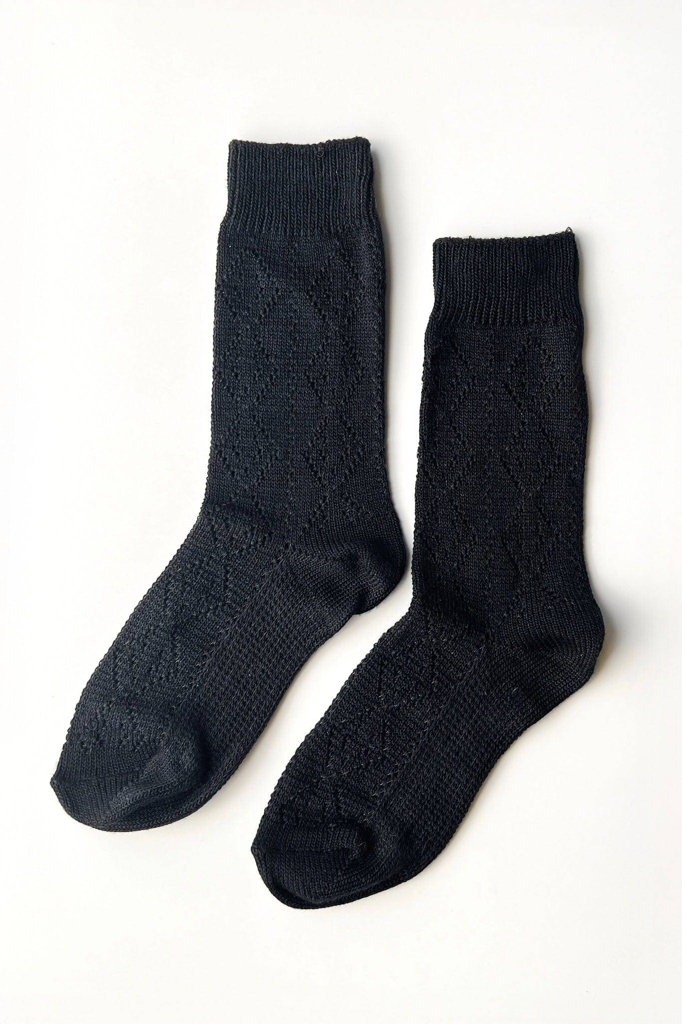 Pair of black socks on a white background