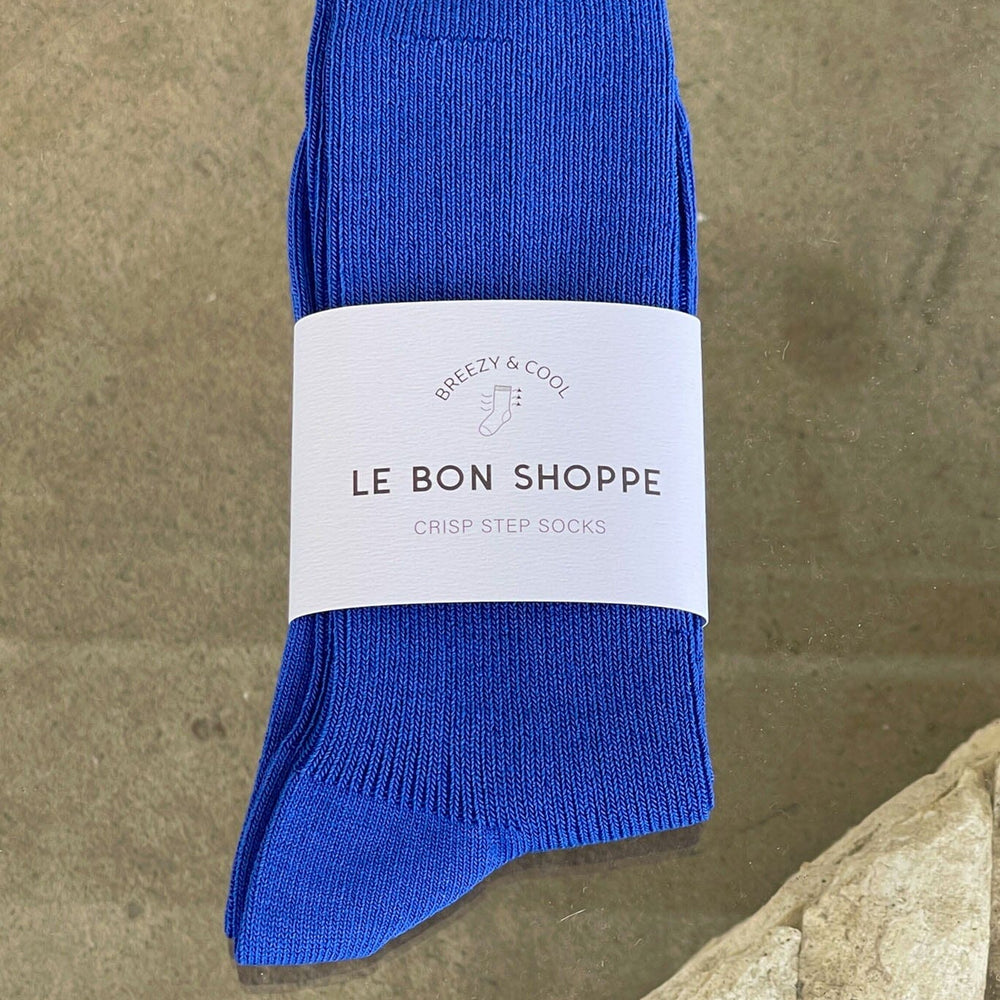 Blue socks with a white label on a stone surface