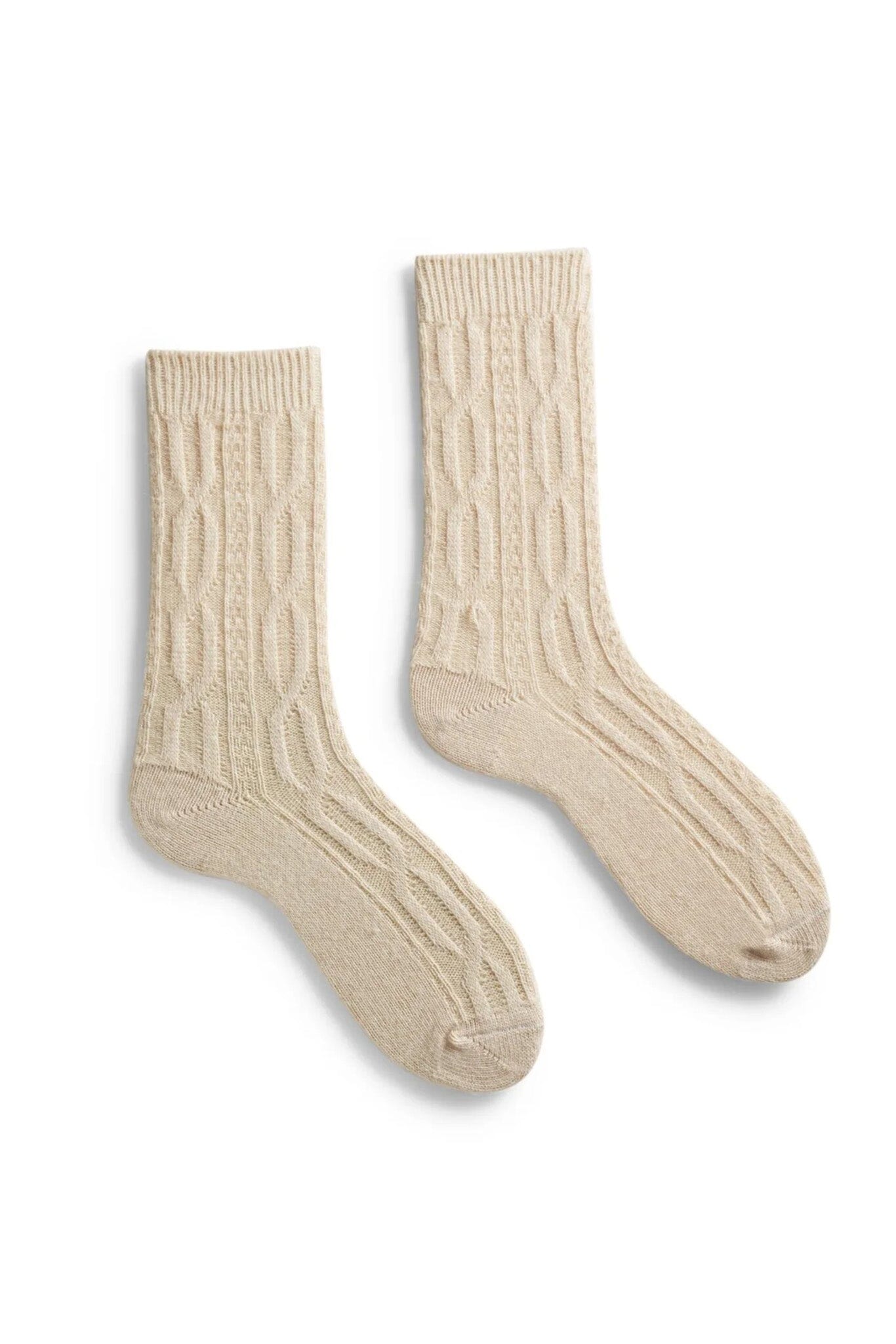 Pair of beige cable-knit socks on a white background