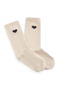 Beige socks with black heart designs on a white background