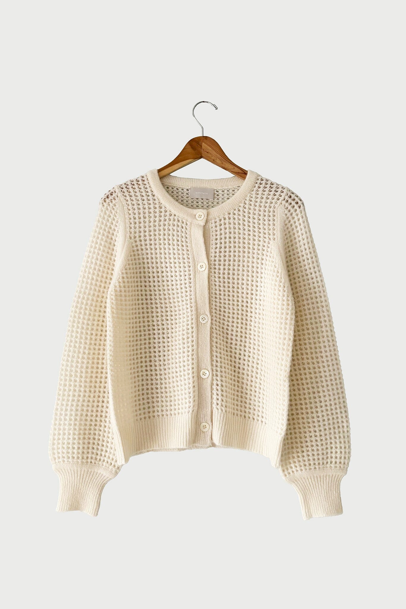 The medium Devin Mesh Cardigan in Ivory by M.Patmos is a  lightweight women's cardigan with an elegant mesh design, perfect for year-round layering.